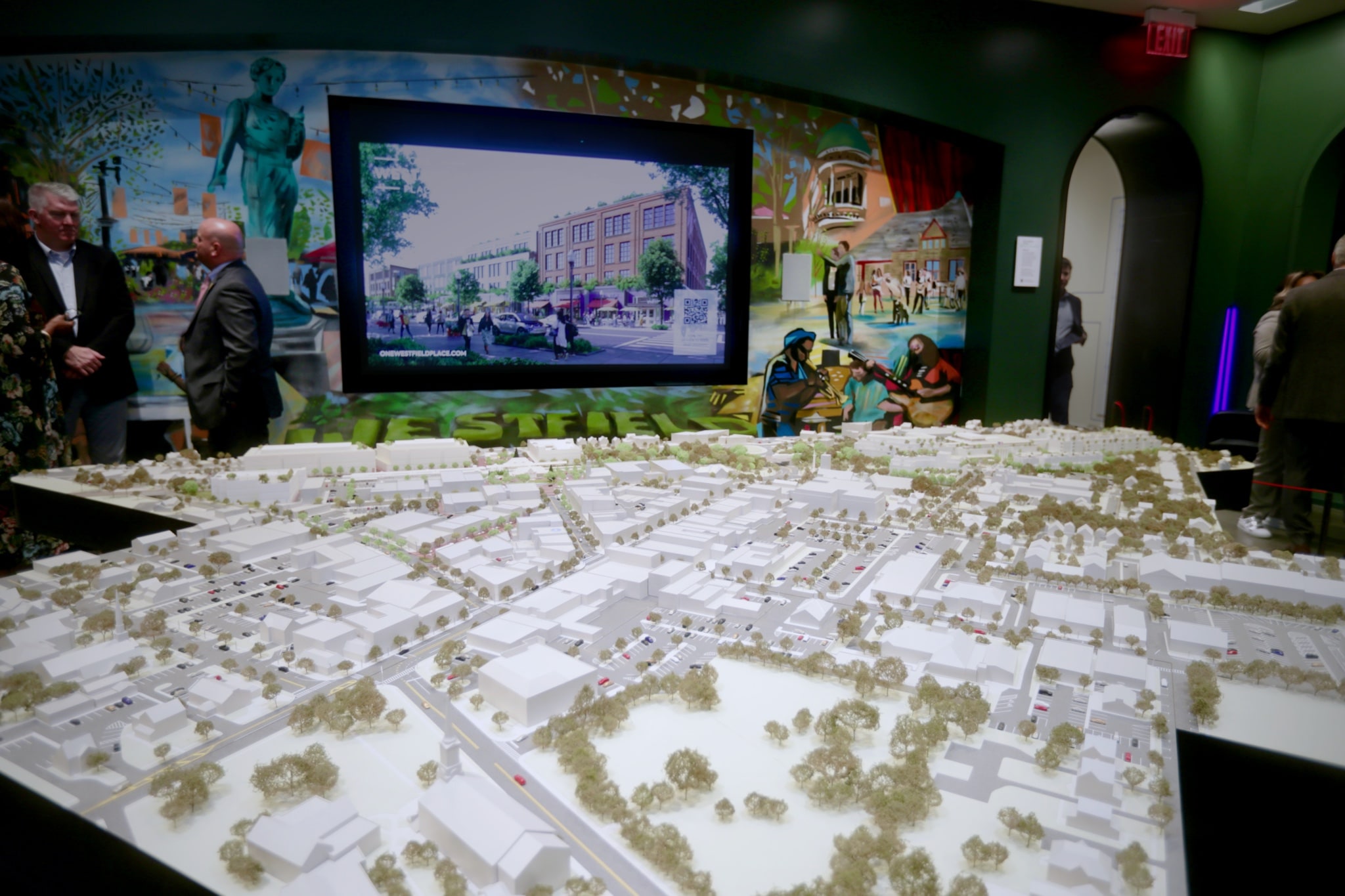 Interactive video wall controlled with a remote iPad, featuring in-depth information, renders, key maps and statistics for each part of the masterplan, and synced with the lighting of a 14-foot physical model of the development