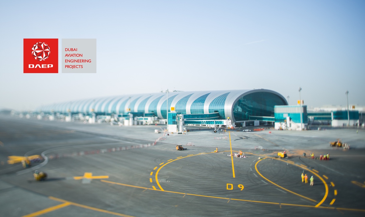 a view of an airport from a plane window and the logo of DAEP