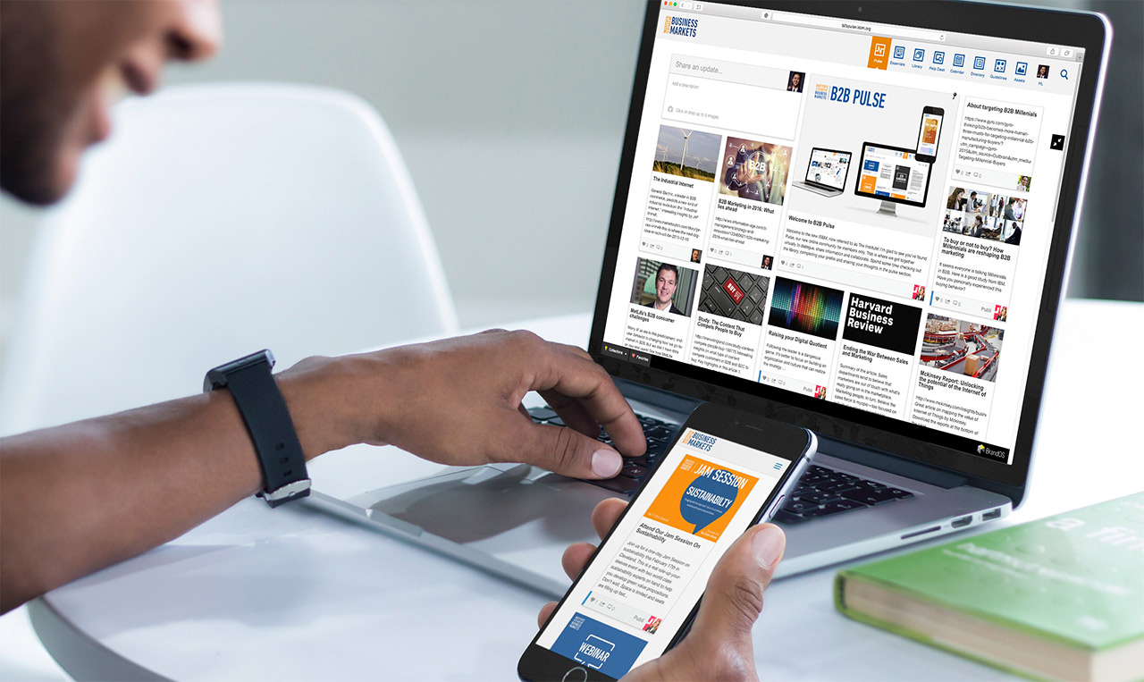 A man multitasking with a laptop and a cell phone.