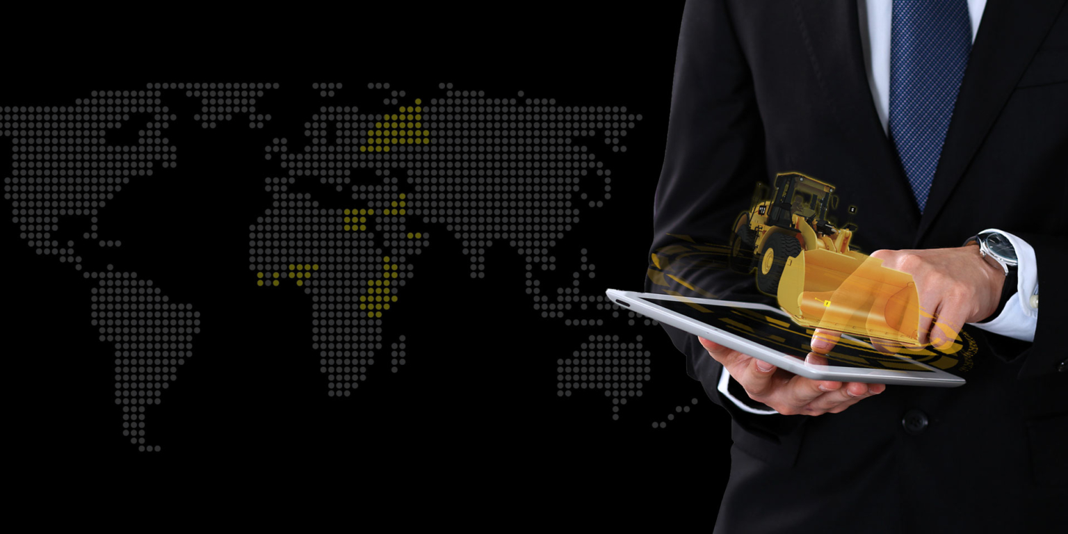 A man in a suit holds a tablet with a 3D model of a caterpillar at the top of the screen.