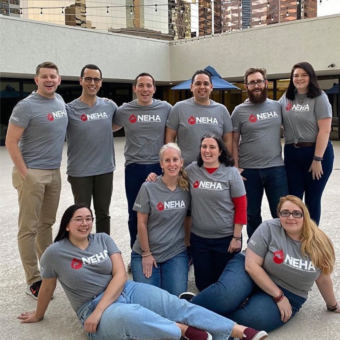 a group of people wearing T-shirts with the NEHA logo