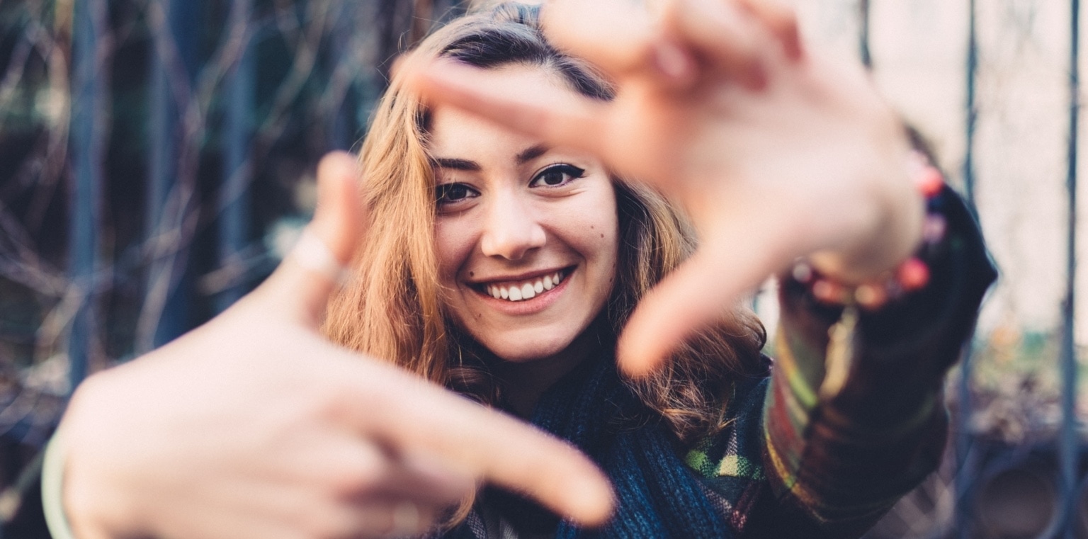 a young woman making a square shape with her hands