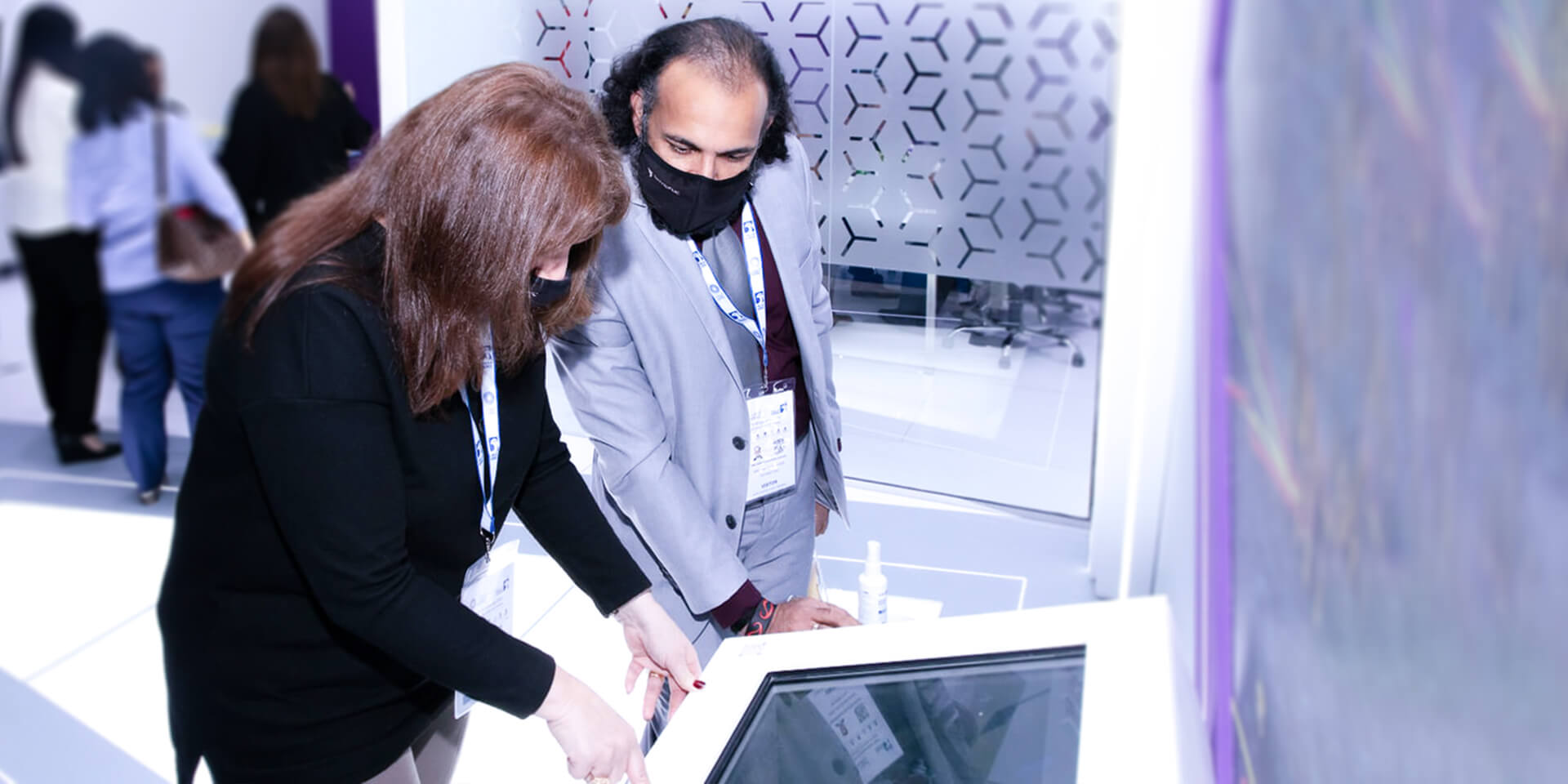 a person pointing at a touch screen showing the presentation developed for TechnipFMC