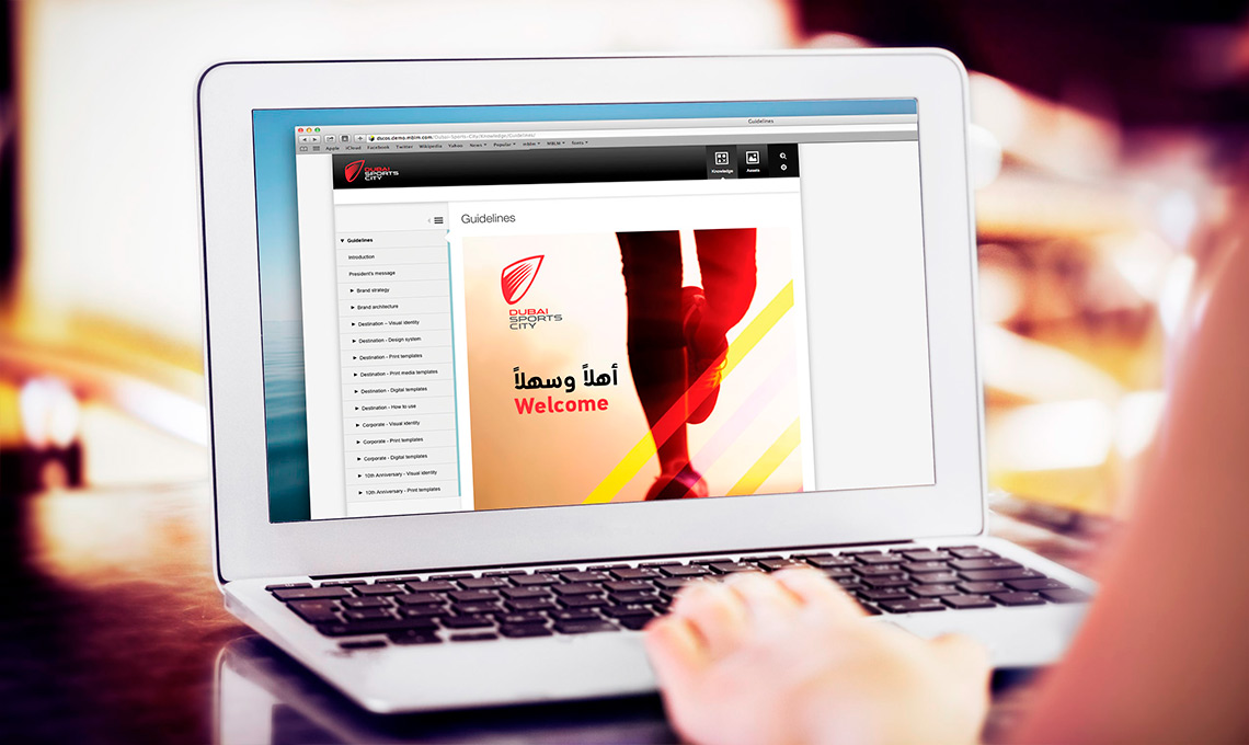 A woman is using a laptop as part of a rebranding program.