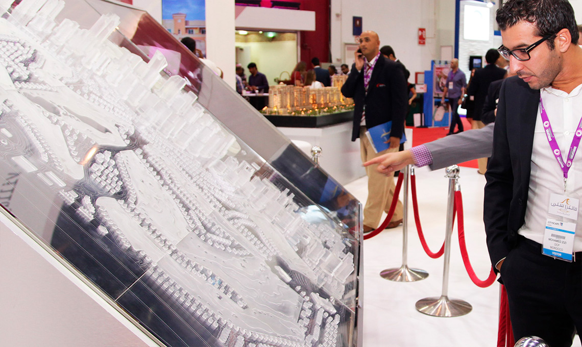 A man in a suit examining a model of a city, redefining the home-field advantage.