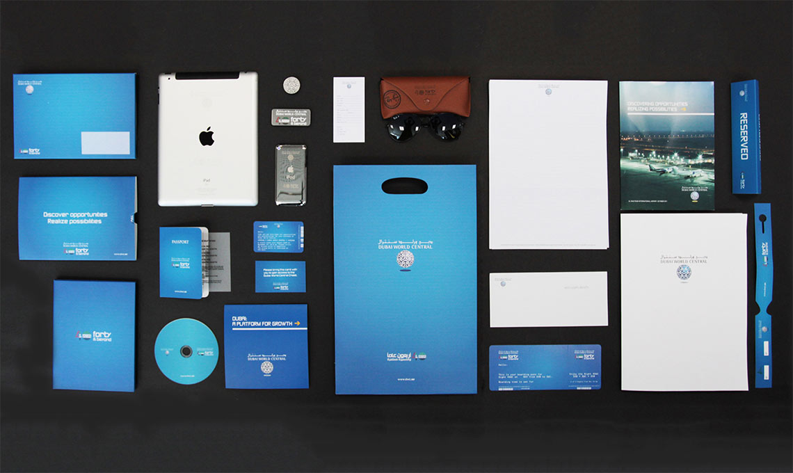 A variety of blue business cards are laid out on a table.