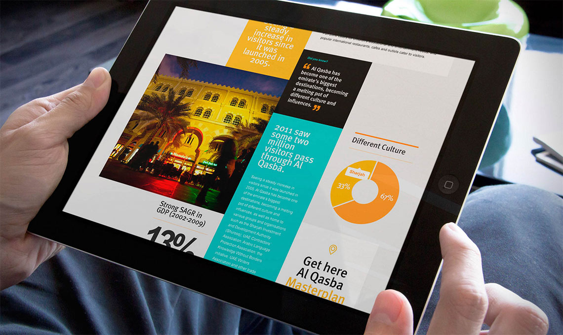 A person holding an ipad with a corporate website on it.