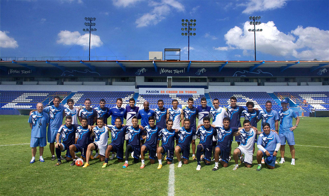 A soccer team capturing a new vision while posing for a picture.