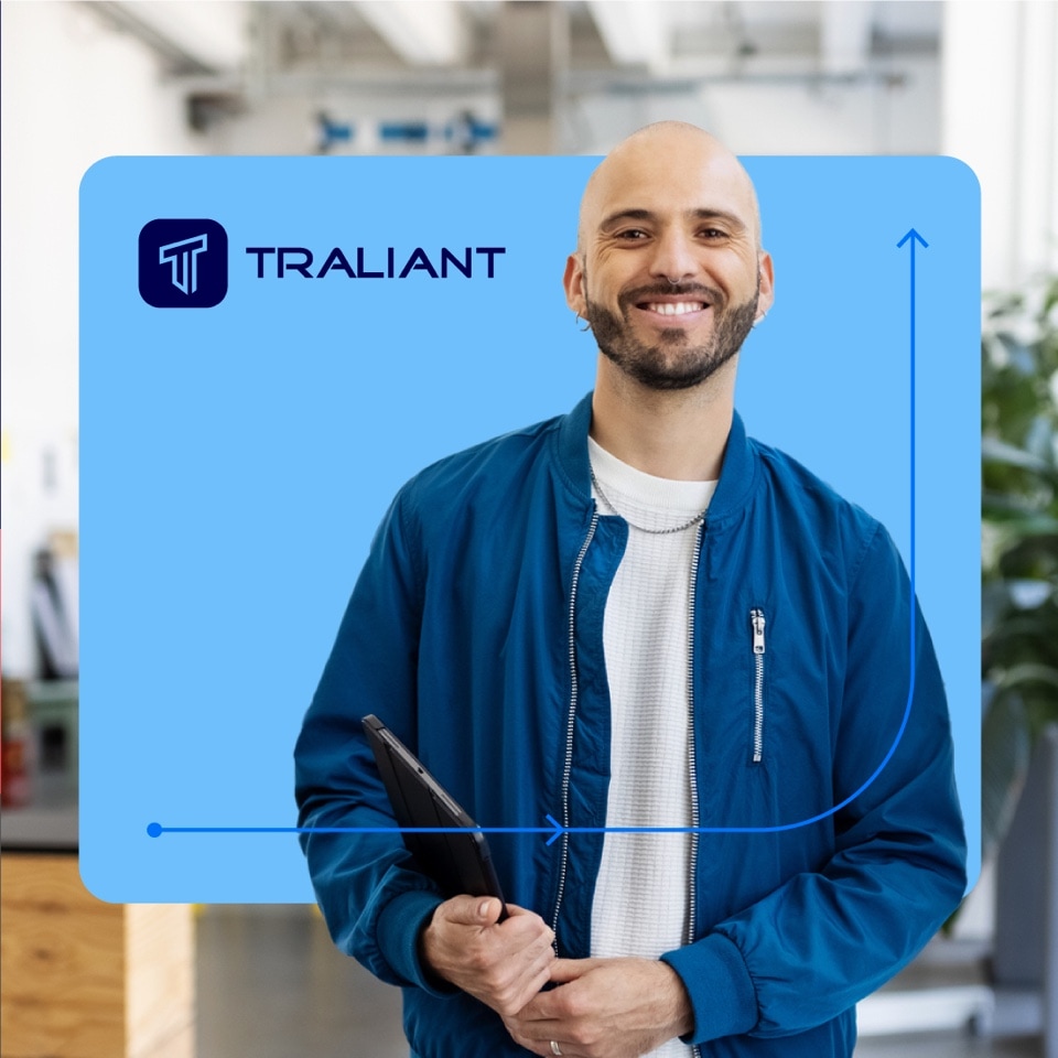Examples of the design system developed for Traliant: A smiling young man with a tablet in his hands.
