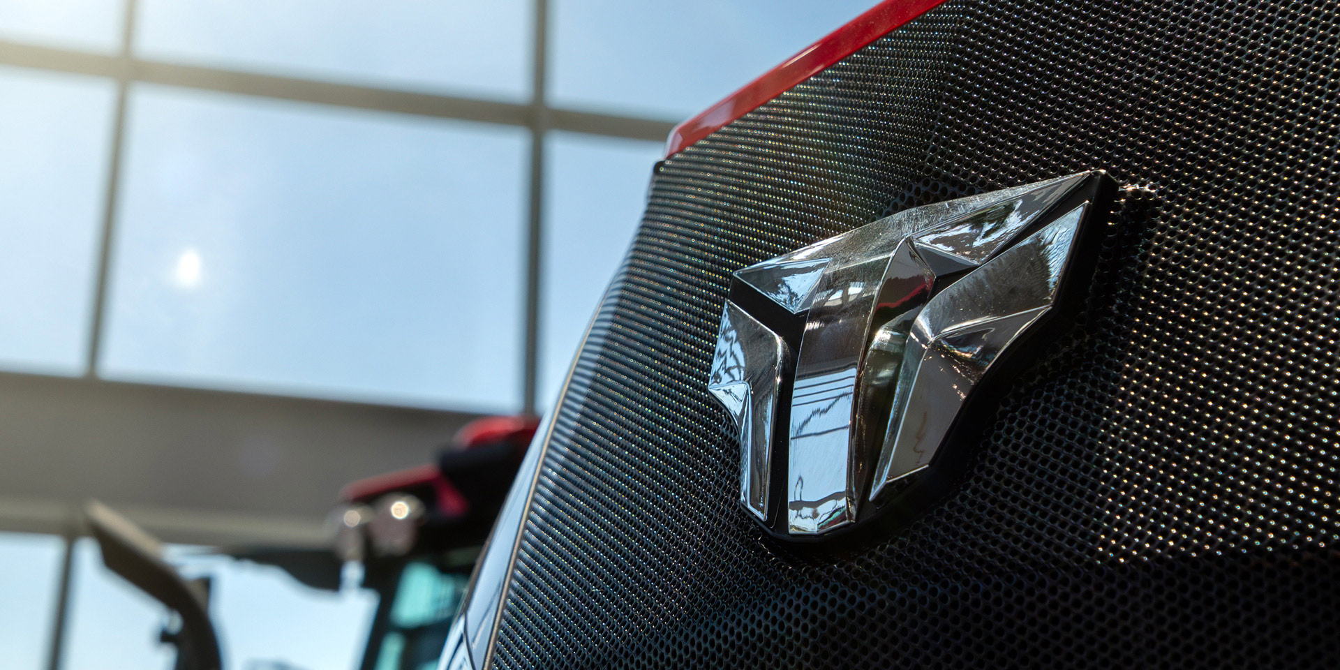 Detailed view of the TYM logo symbol on the tractor.