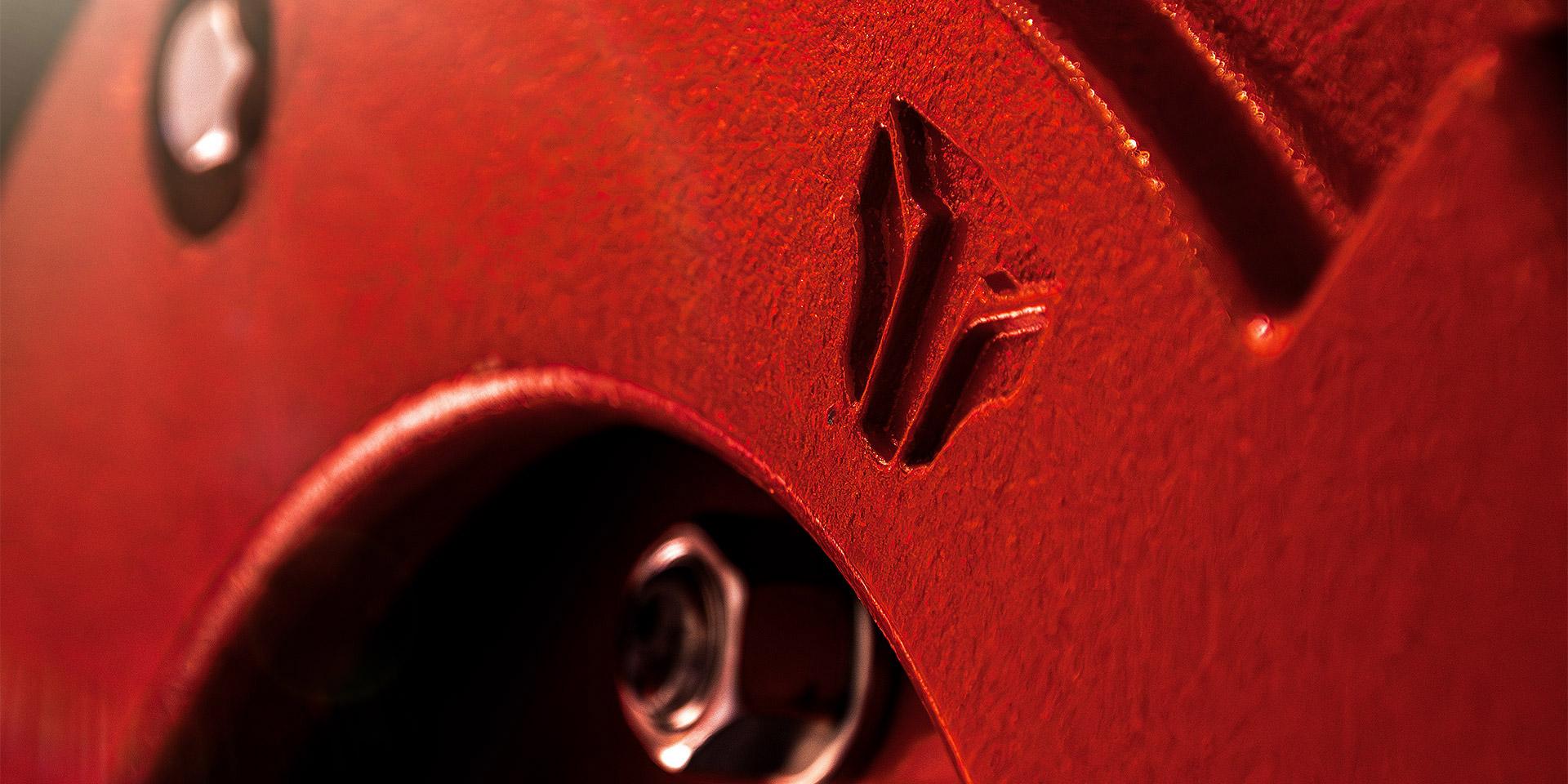 Close-up of a TYM tractor with Tiger-faced TYM logo engraving, designed by OMNRAE.