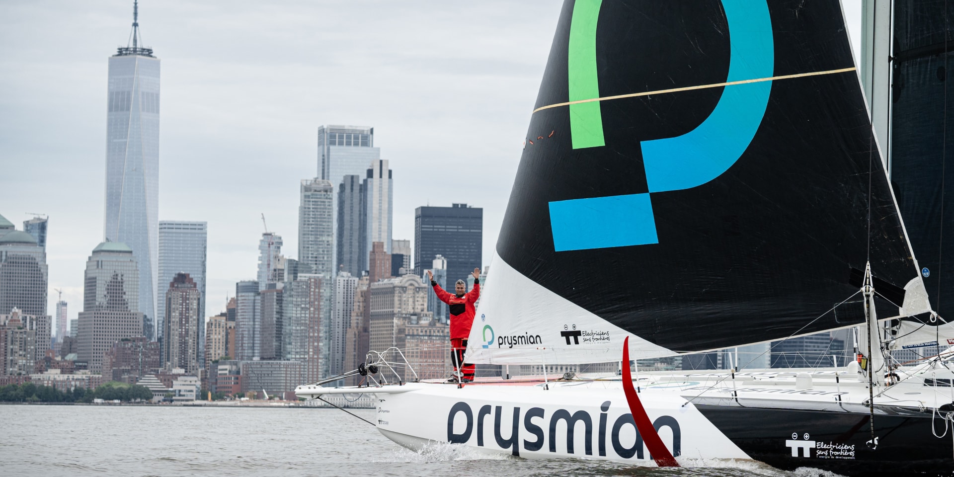 Prymian's logo on the side of a sailboat with the manhattan cityline in the background